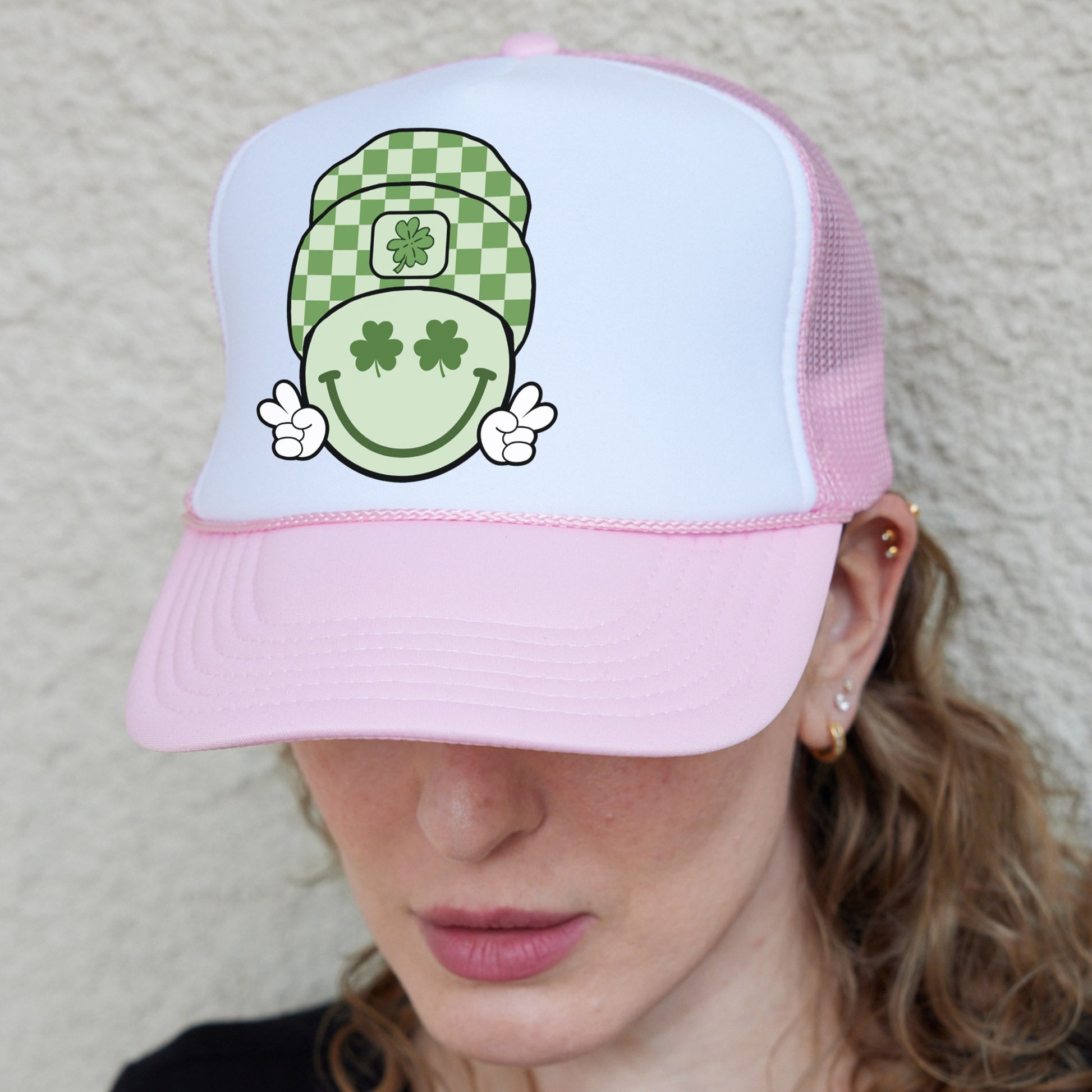 a woman wearing a pink and white hat