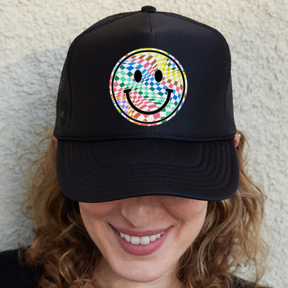 a woman wearing a black hat with a smiley face on it