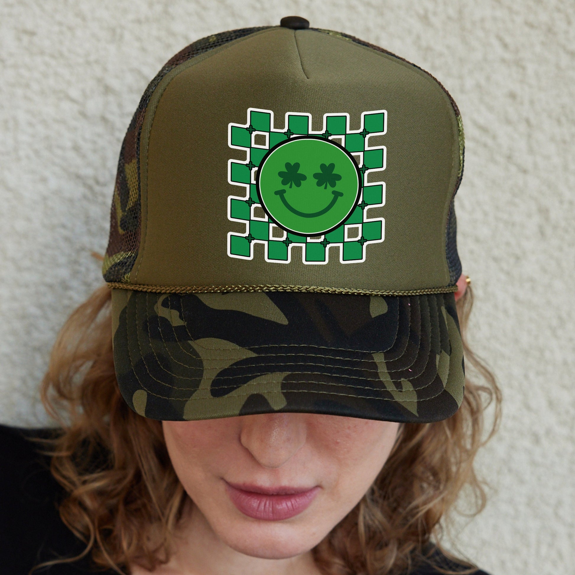 a woman wearing a green hat with a smiling face