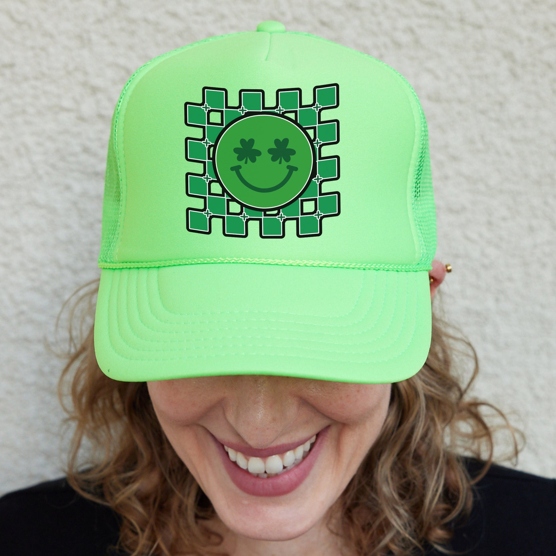 a woman wearing a green hat with a smiling face