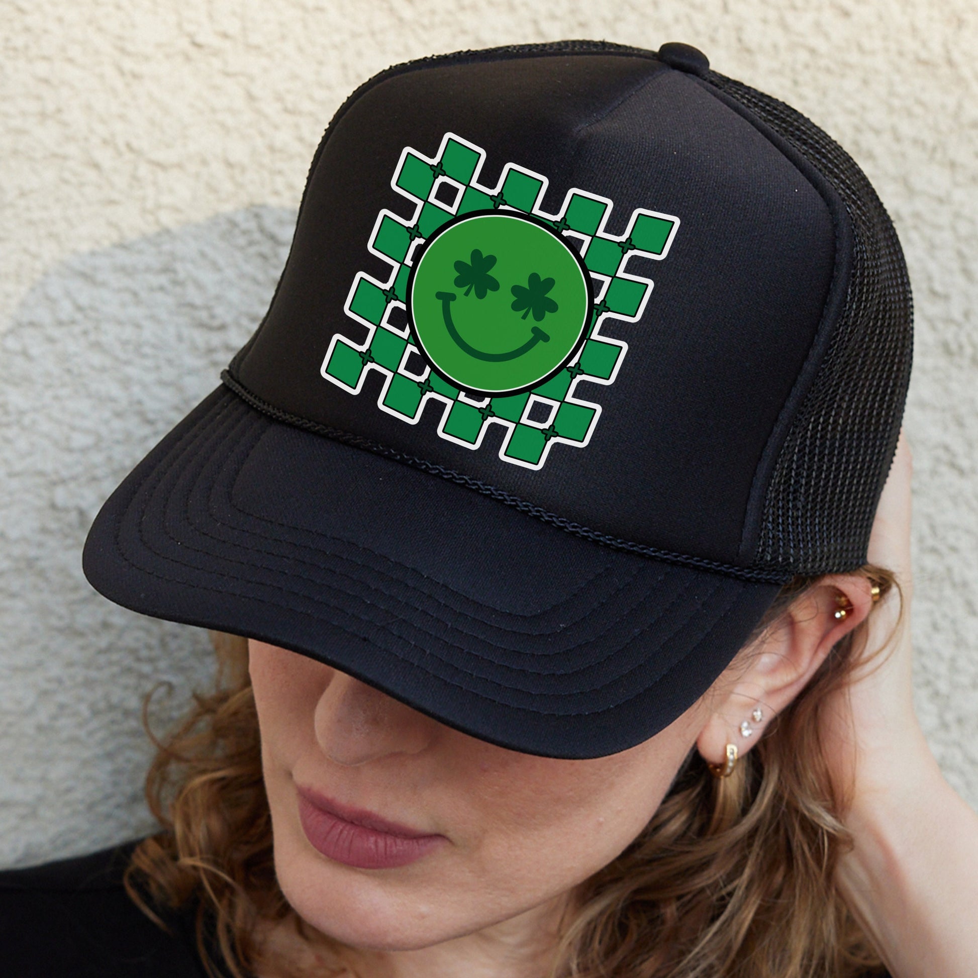a woman wearing a hat with a smiley face on it