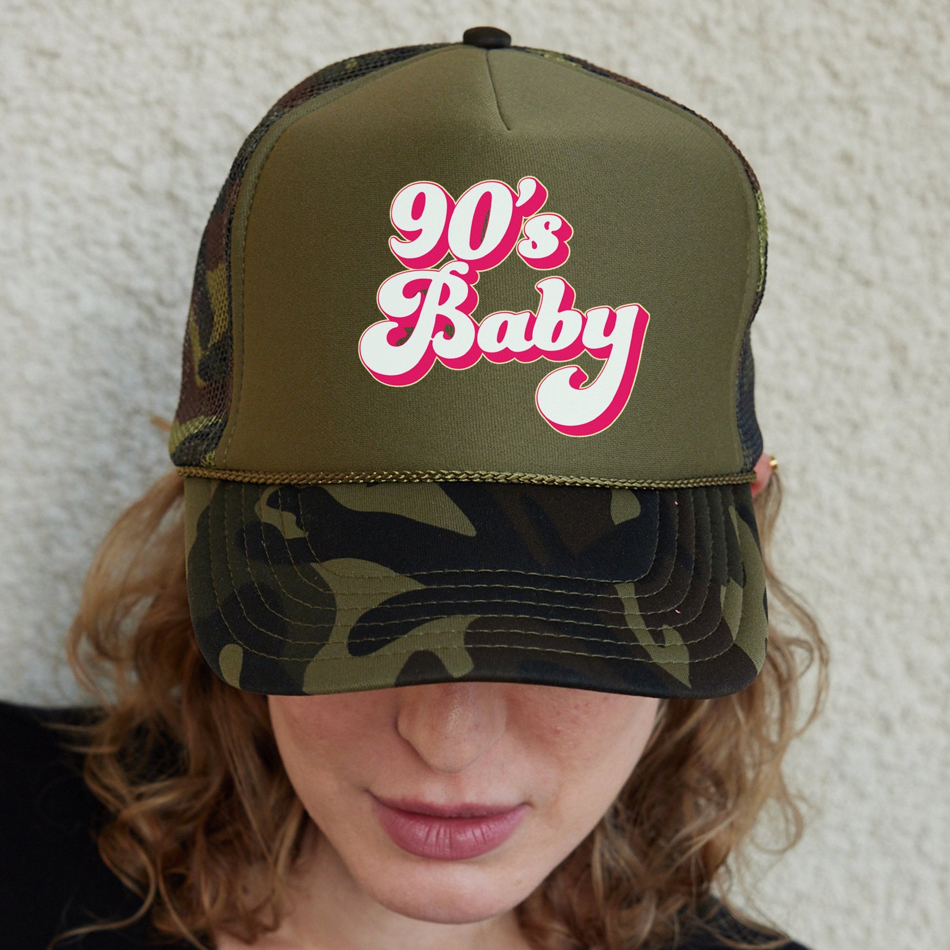 a woman wearing a hat that says 90&#39;s baby