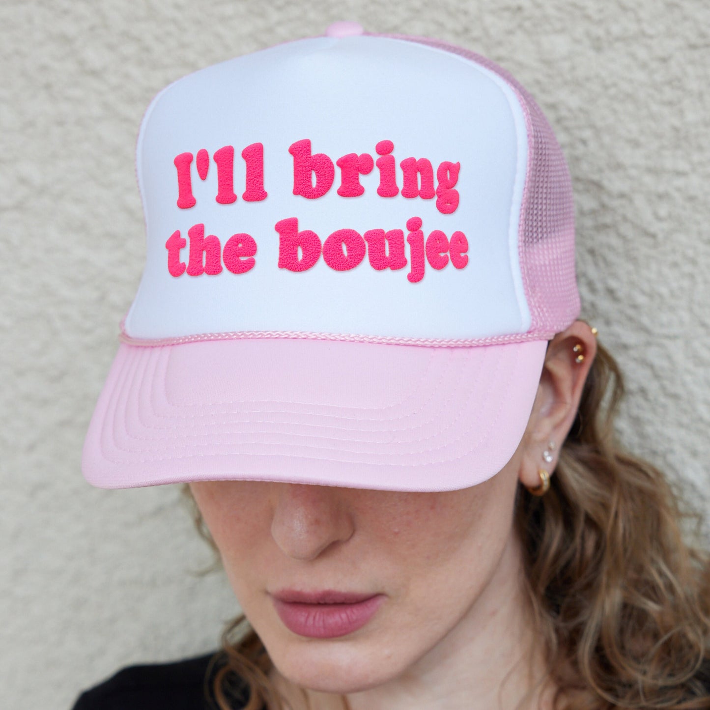 a woman wearing a pink and white hat with the words i&#39;ll bring the