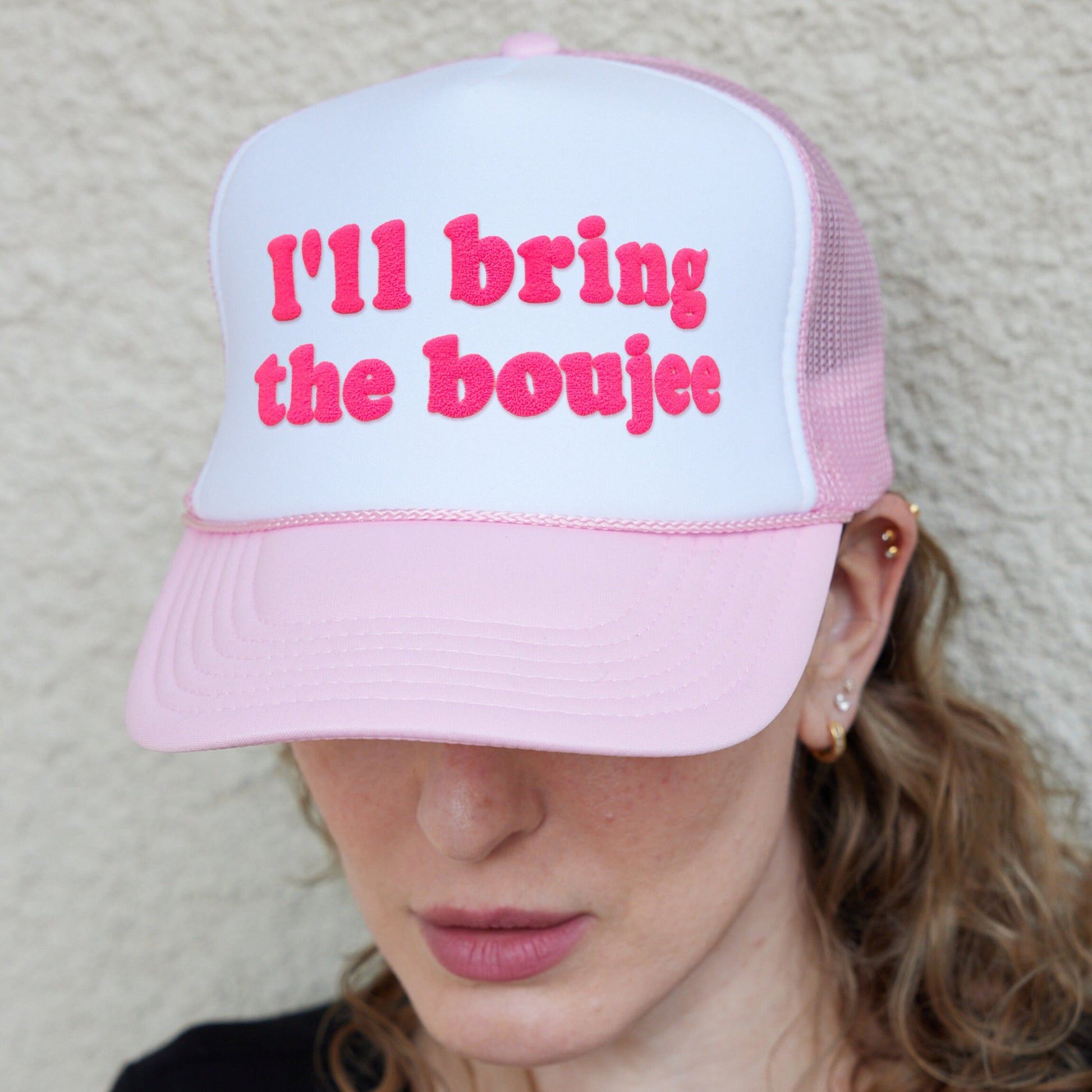 a woman wearing a pink and white hat with the words i&#39;ll bring the