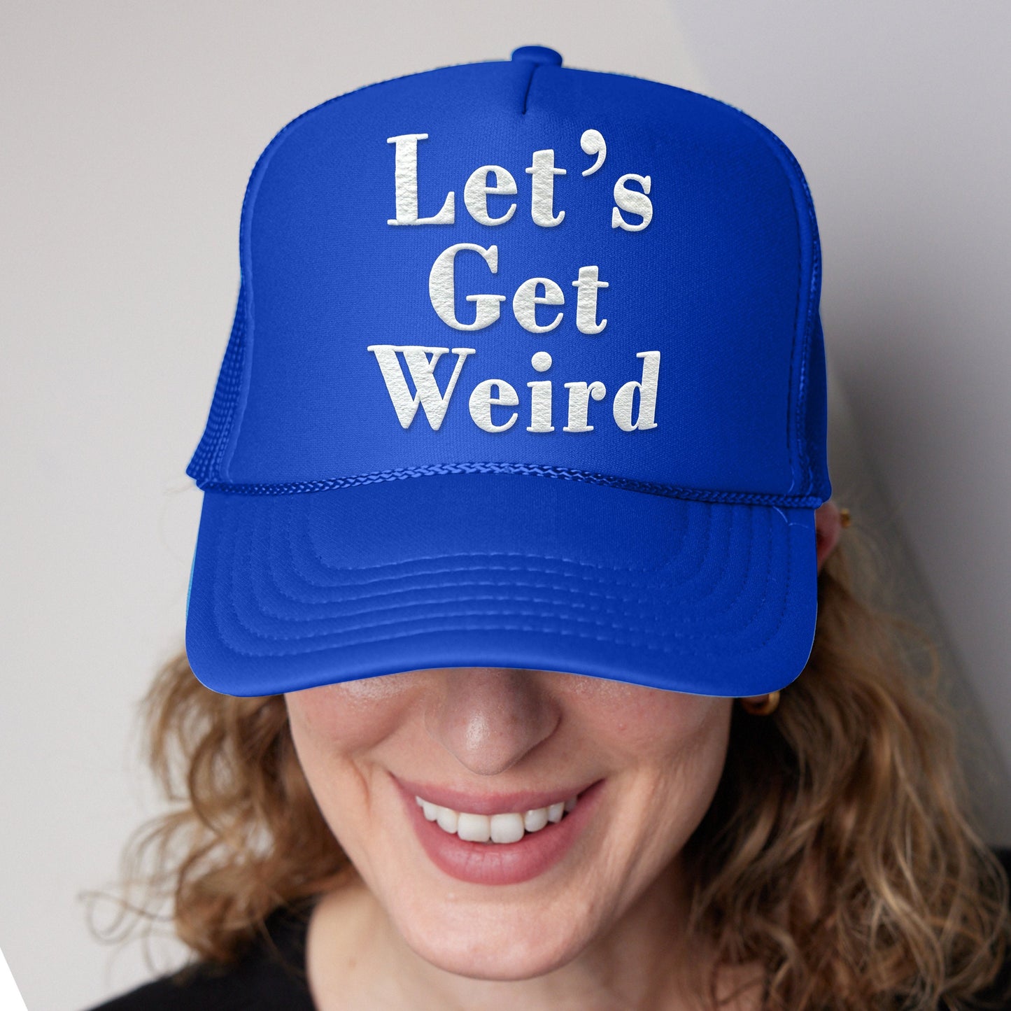 a woman wearing a blue hat that says let&#39;s get weird