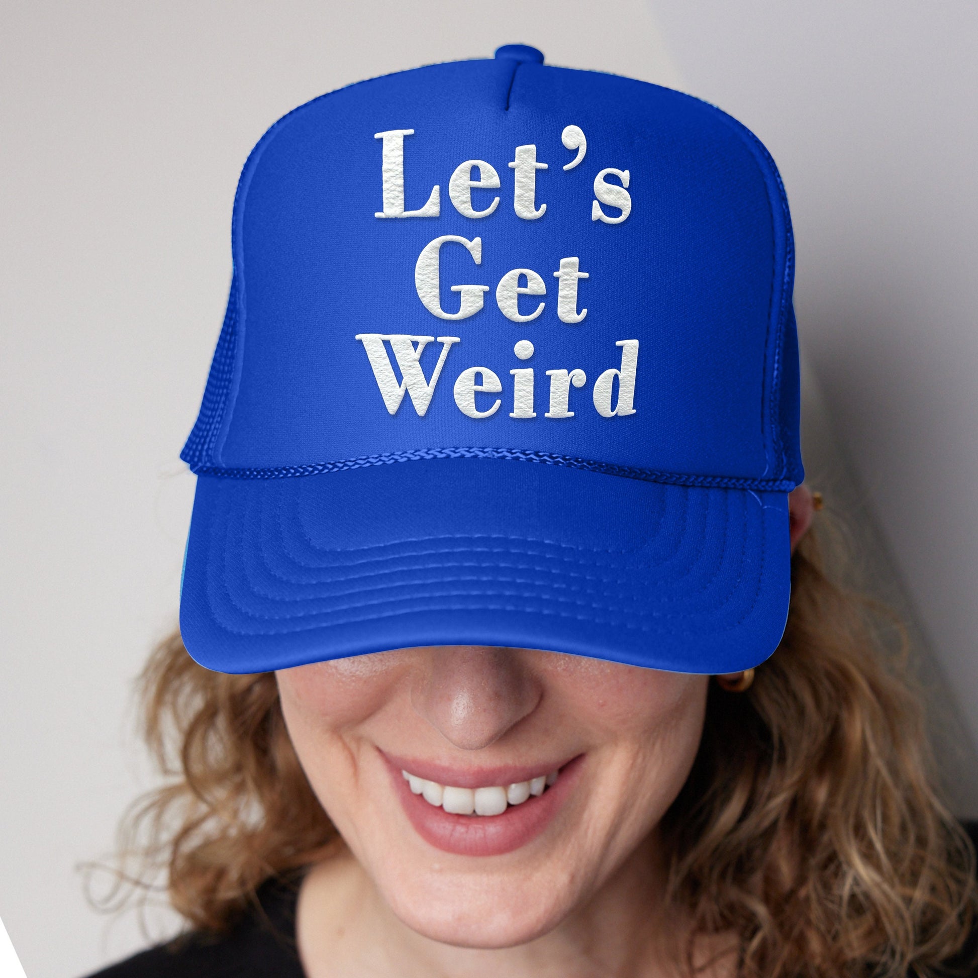 a woman wearing a blue hat that says let&#39;s get weird