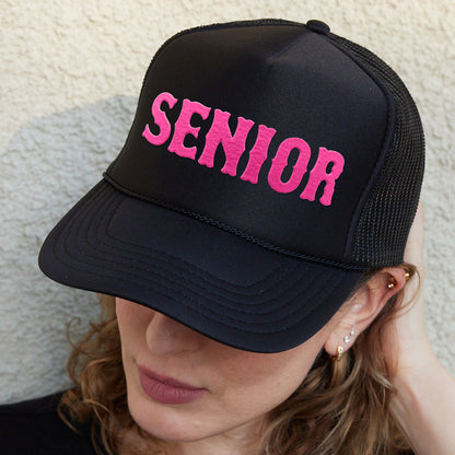 a woman wearing a hat with the word senior on it