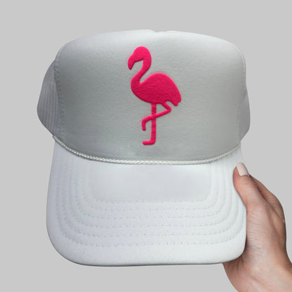 a white hat with a pink flamingo embroidered on it