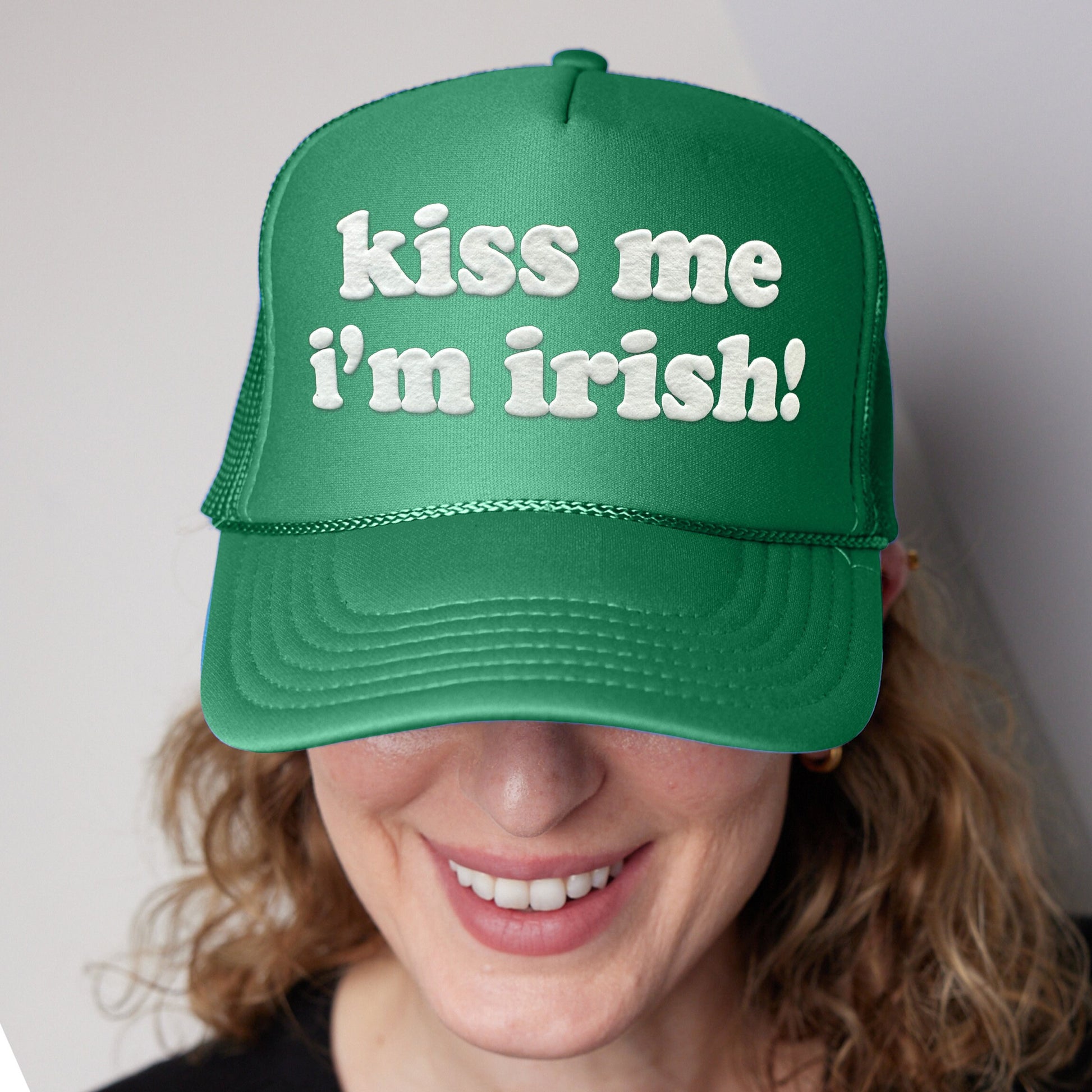 a woman wearing a green hat that says kiss me i&#39;m irish