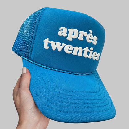 a person holding up a blue hat with the words appre&#39;s twen