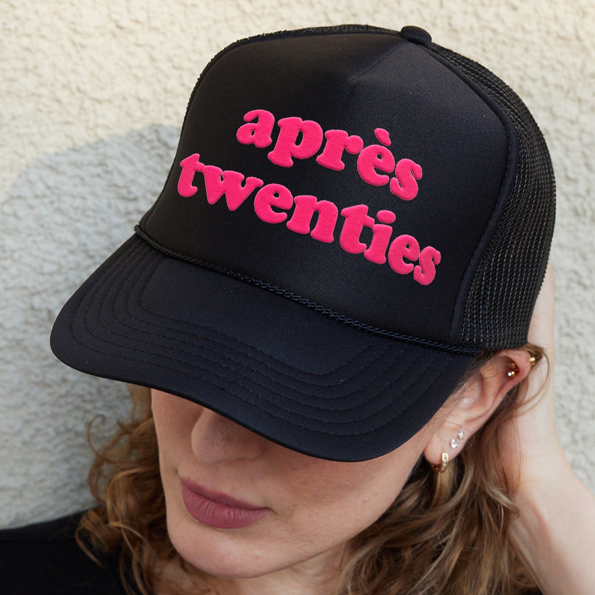 a woman wearing a hat that says apres aventies