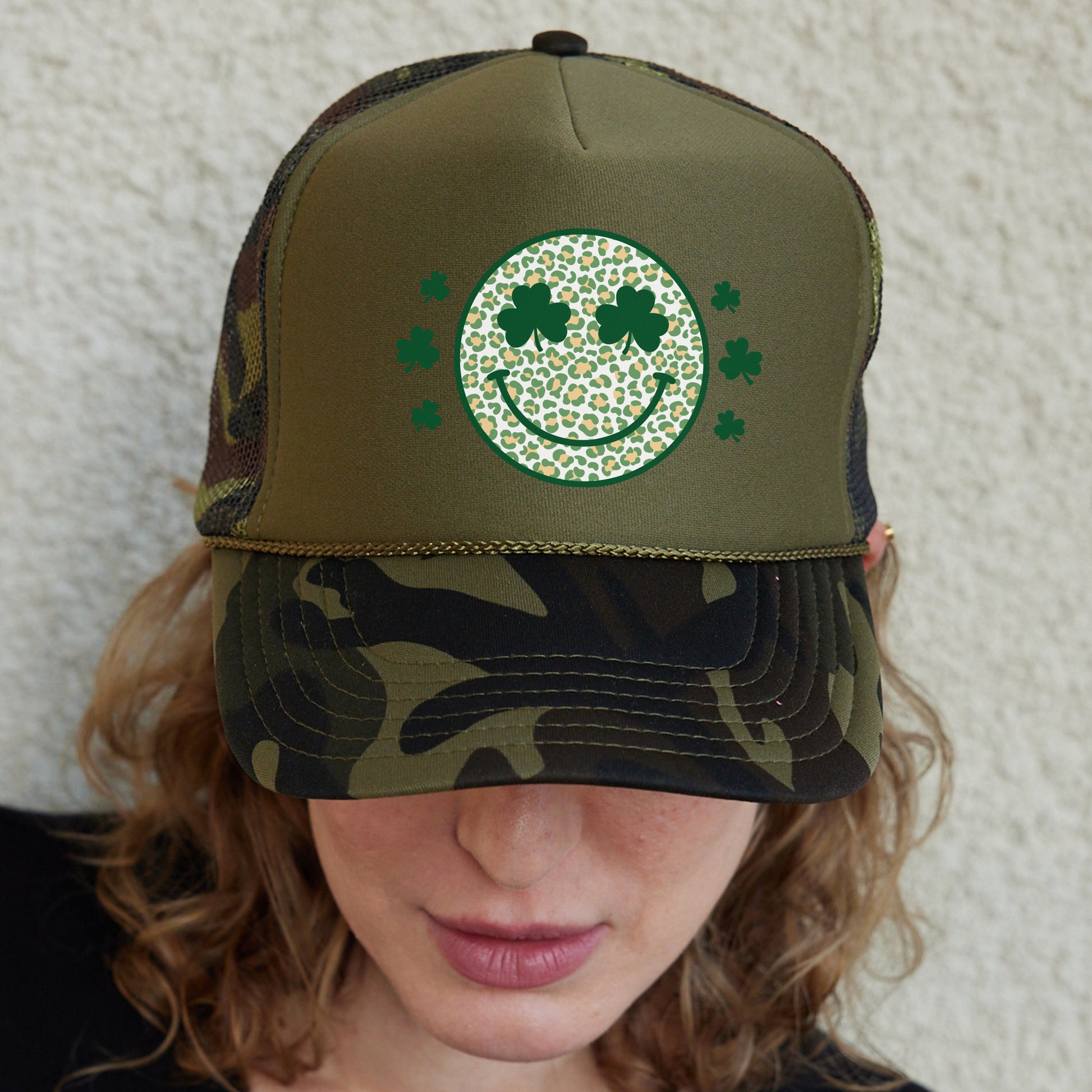 a woman wearing a green hat with a smiling face