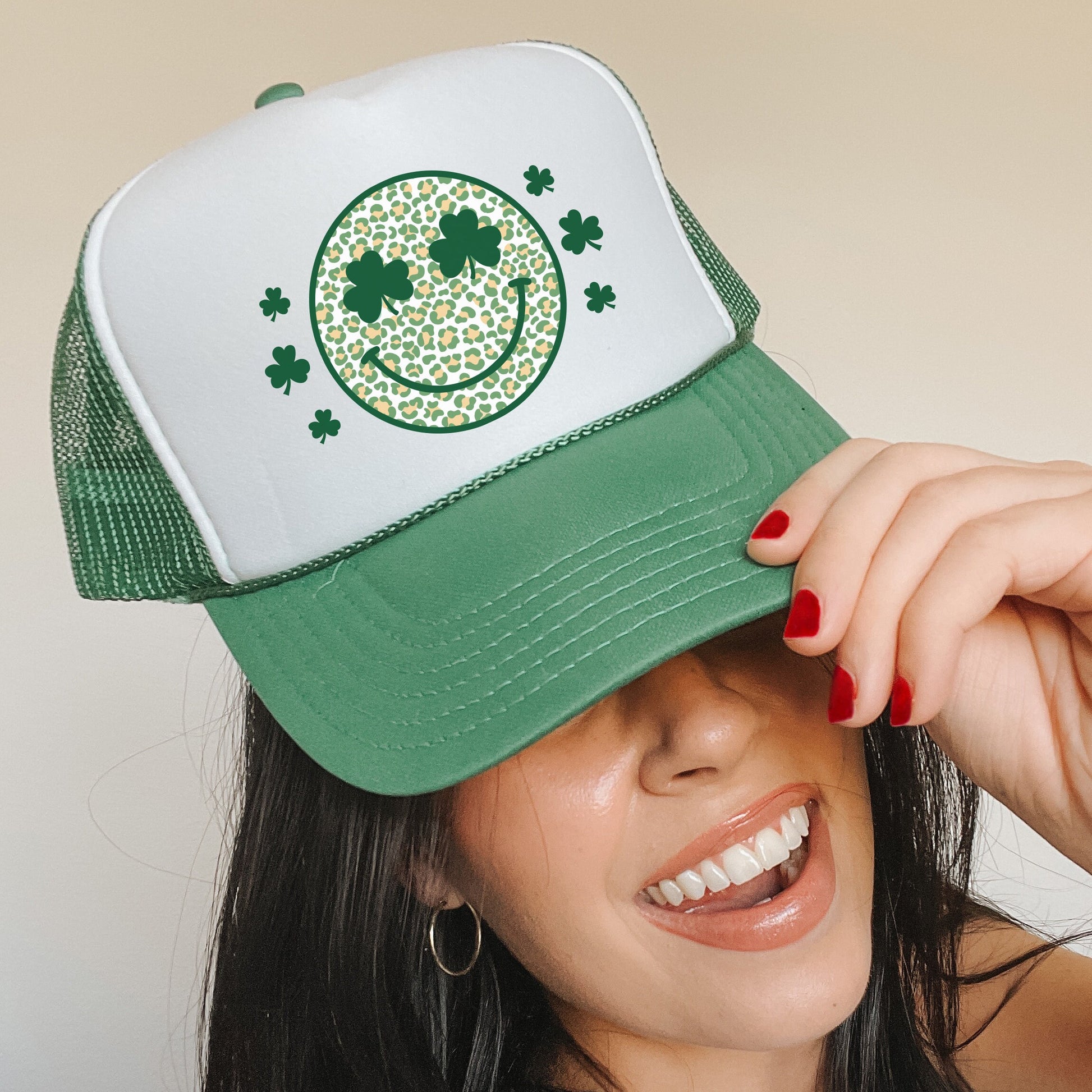 a woman wearing a green and white trucker hat