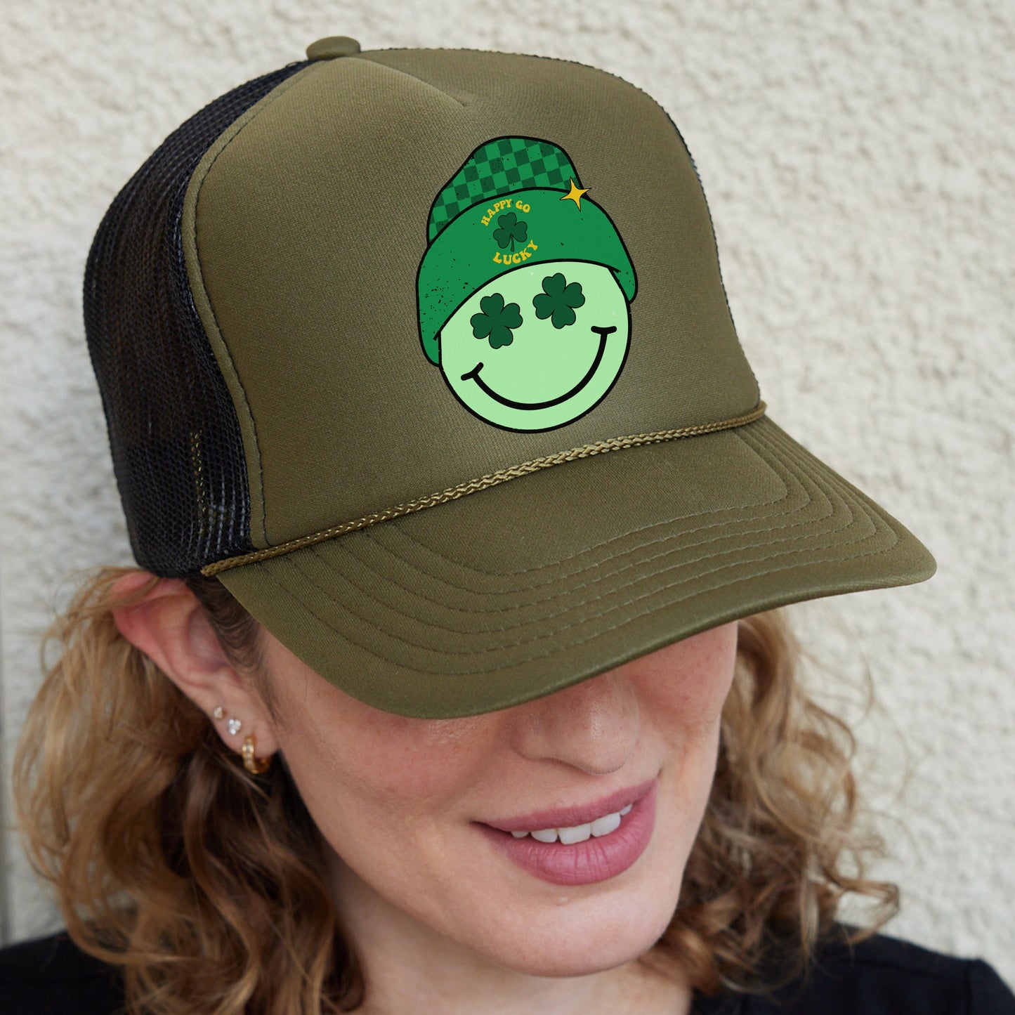 a woman wearing a green hat with a smiling face