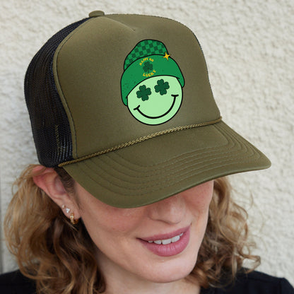 a woman wearing a green hat with a smiling face