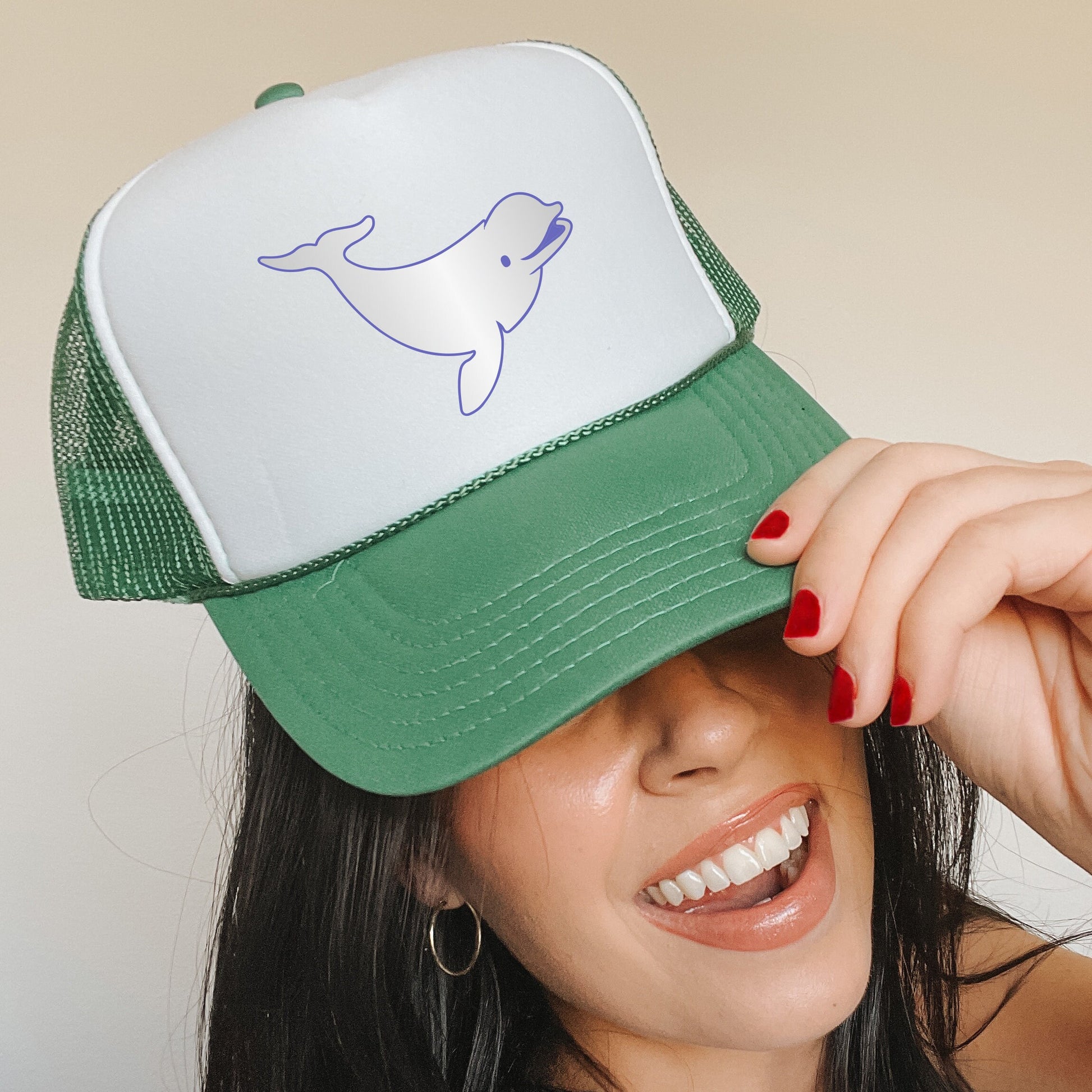 a woman wearing a green and white trucker hat