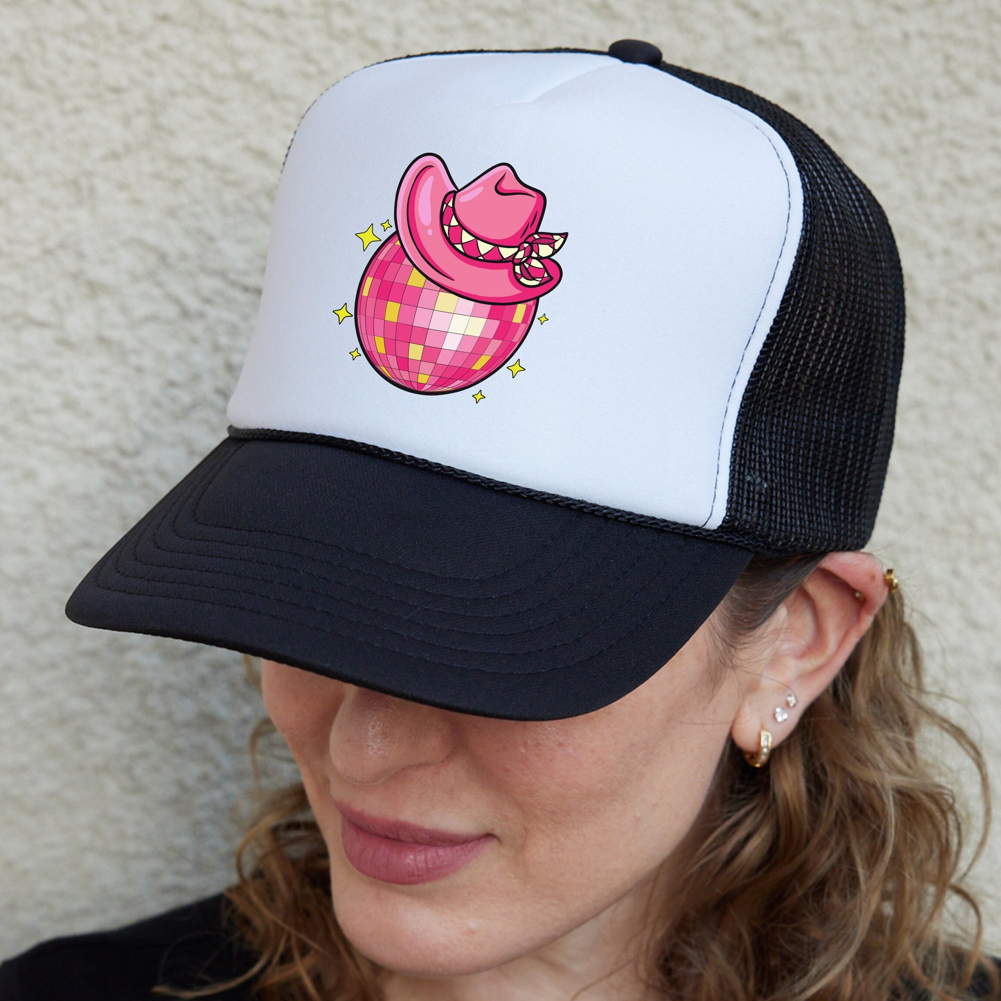 a woman wearing a hat with a pig on it