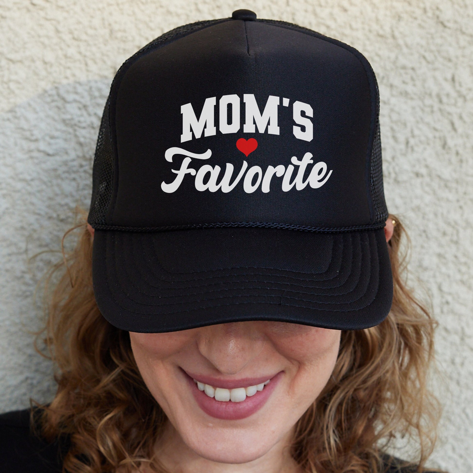 a woman wearing a mom&#39;s favorite trucker hat