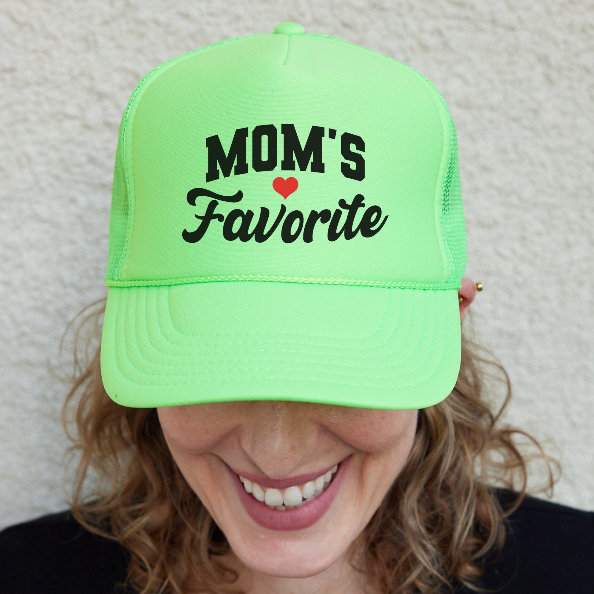 a woman wearing a neon green mom&#39;s favorite hat