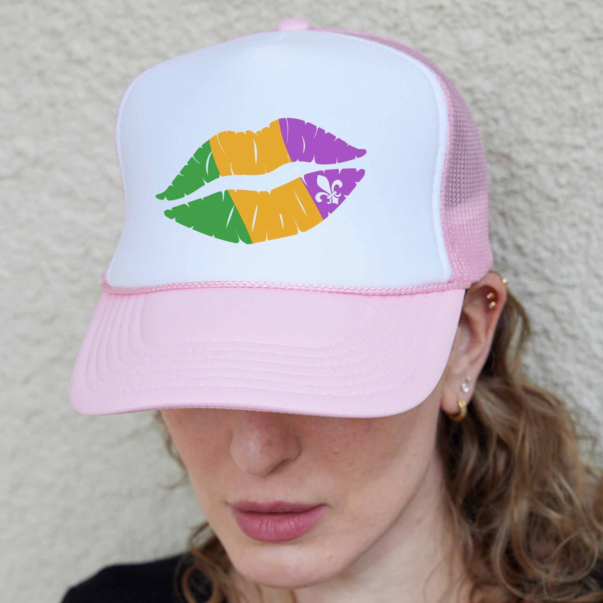 a woman wearing a hat with lipstick painted on it