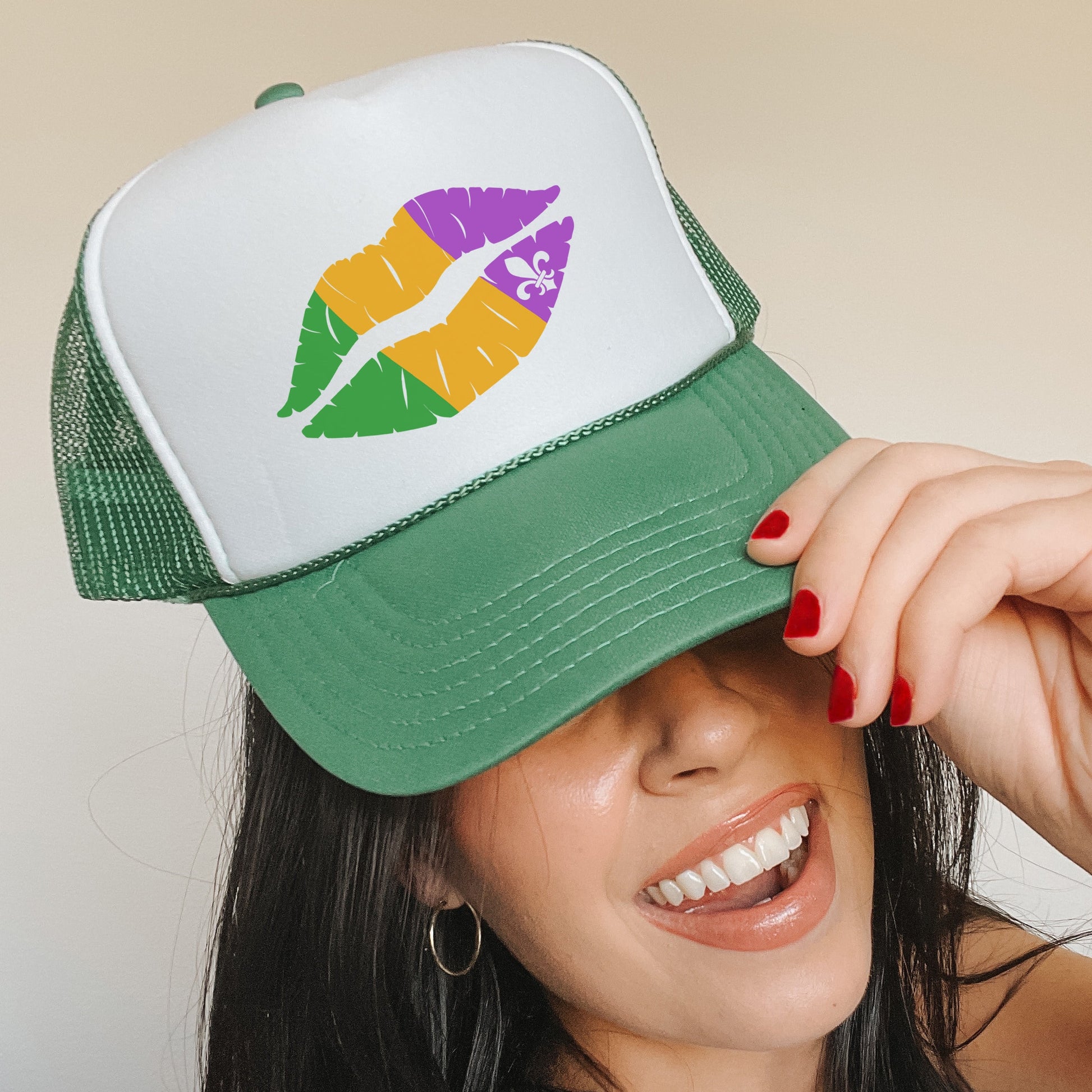 a woman wearing a green and white hat with a kiss on it