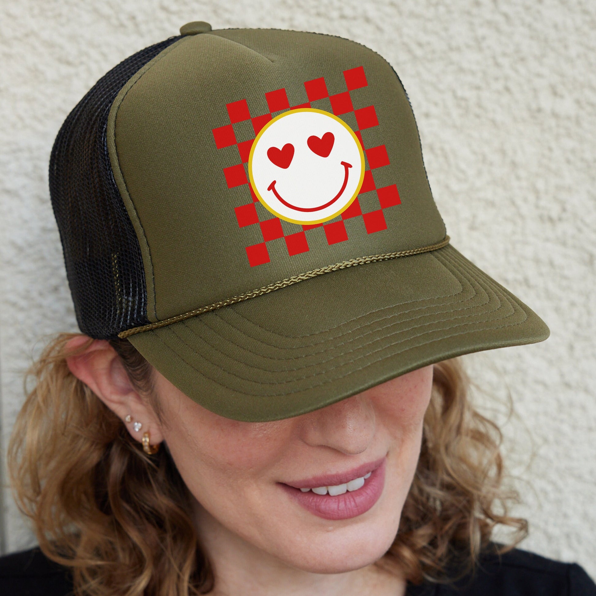 a woman wearing a hat with a smiley face on it