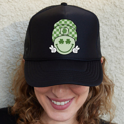 a woman wearing a black hat with a green and white design on it