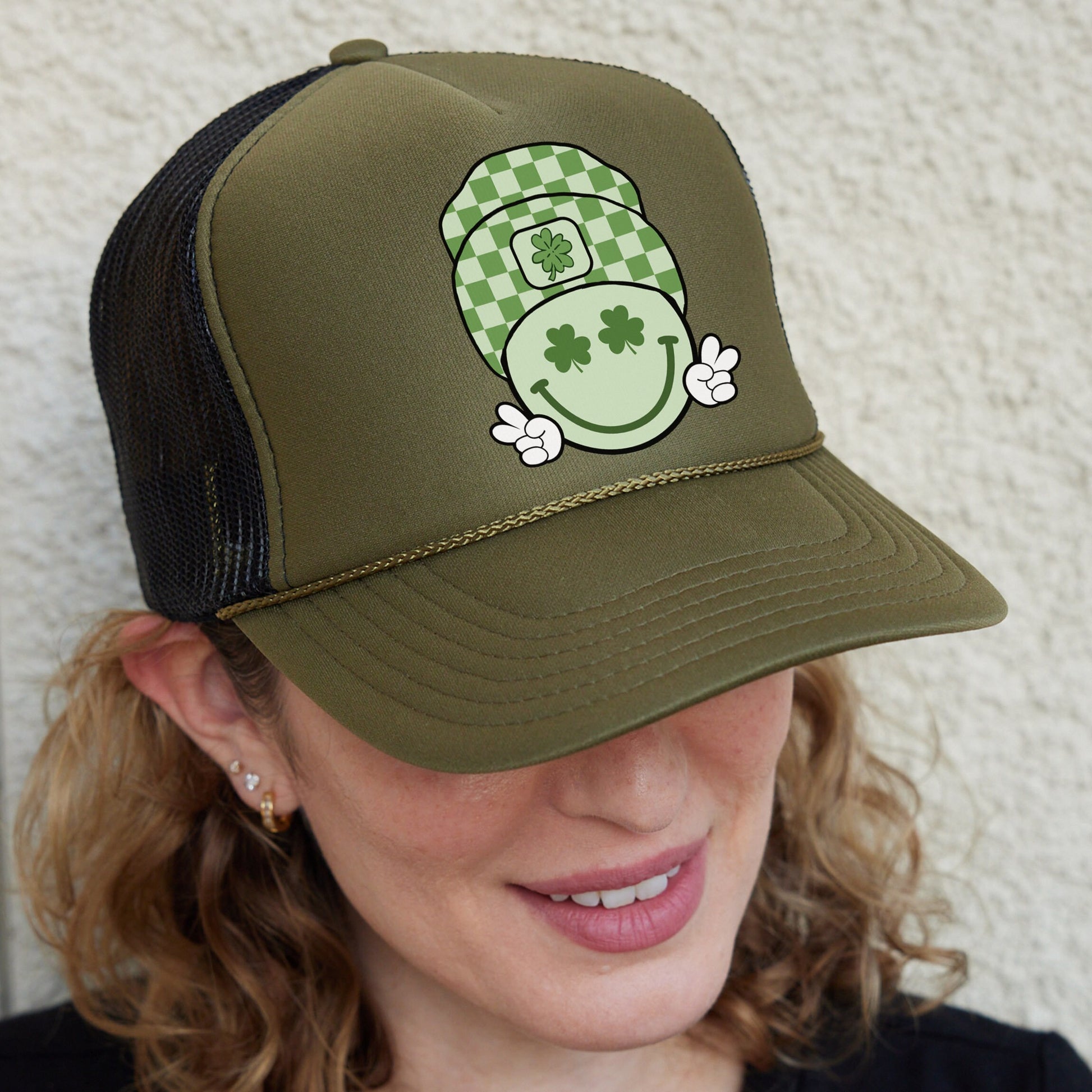 a woman wearing a green hat with a shamrock on it