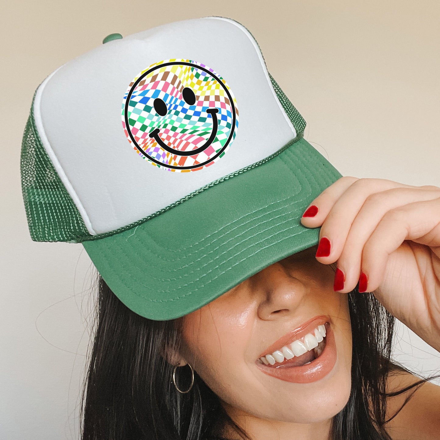 a woman wearing a hat with a smiley face on it