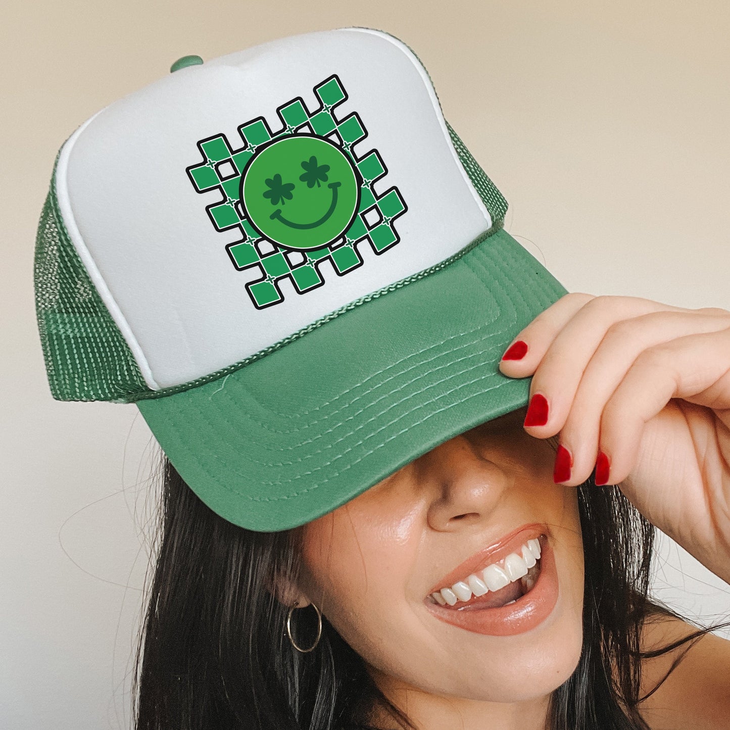 a woman wearing a green and white trucker hat