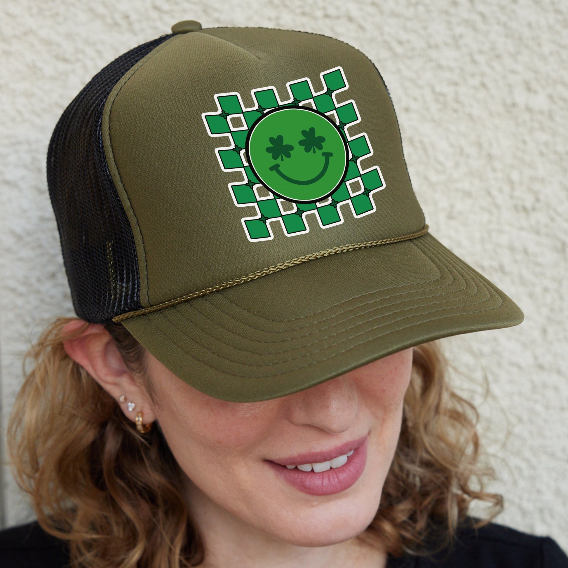 a woman wearing a green hat with a smiling face