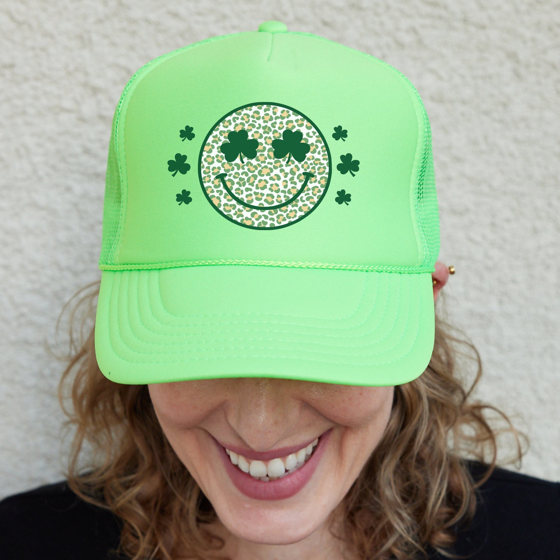 a woman wearing a green hat with a smiling face