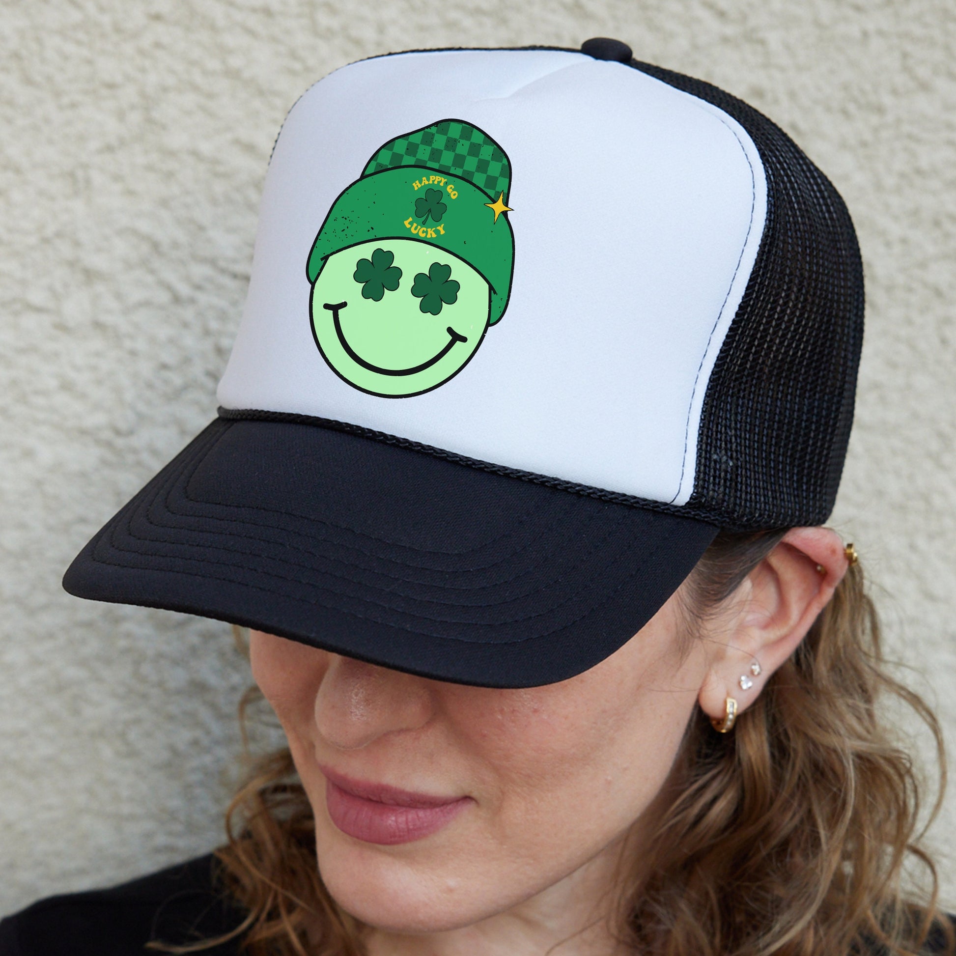 a woman wearing a green hat with a smiley face on it