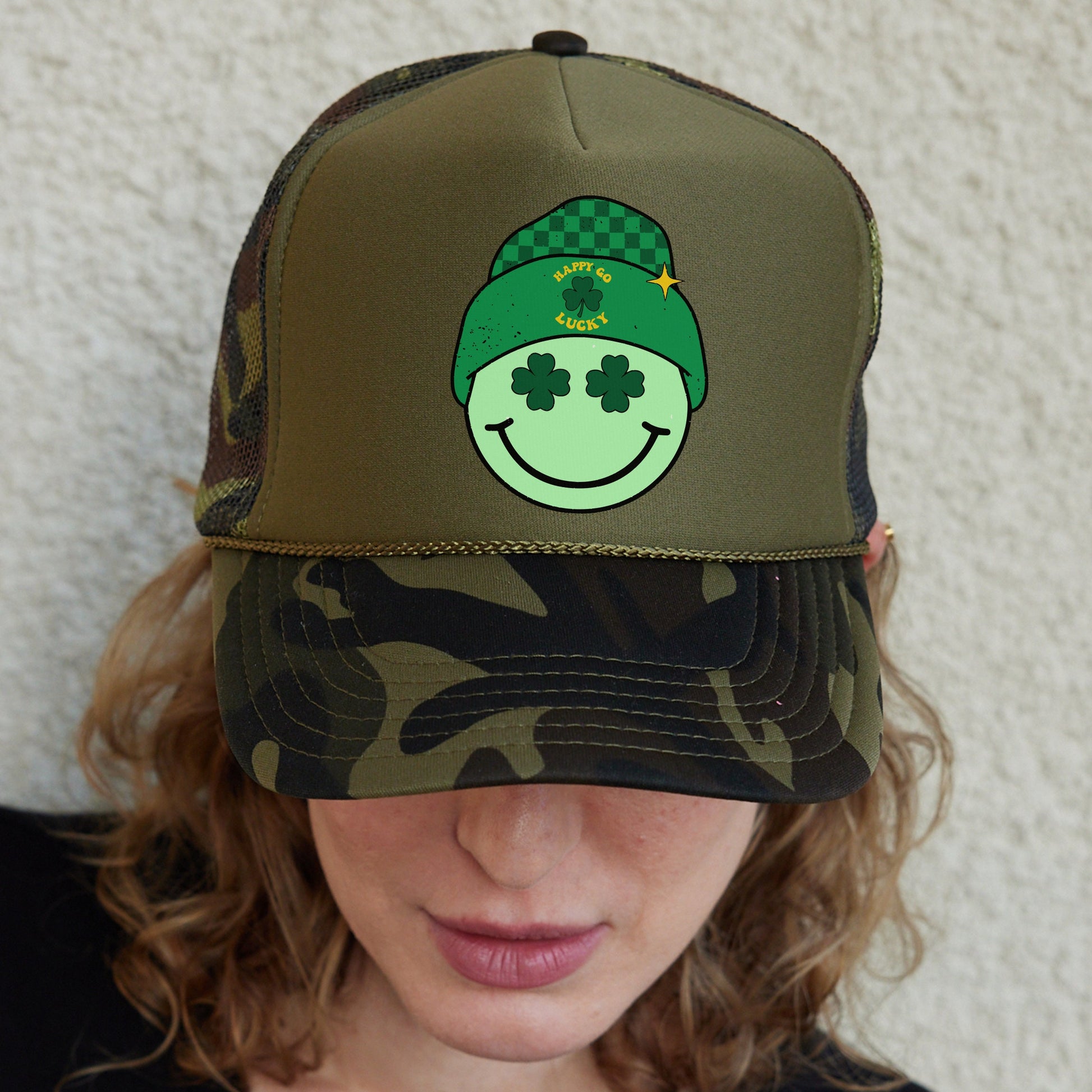 a woman wearing a green hat with a smiling face