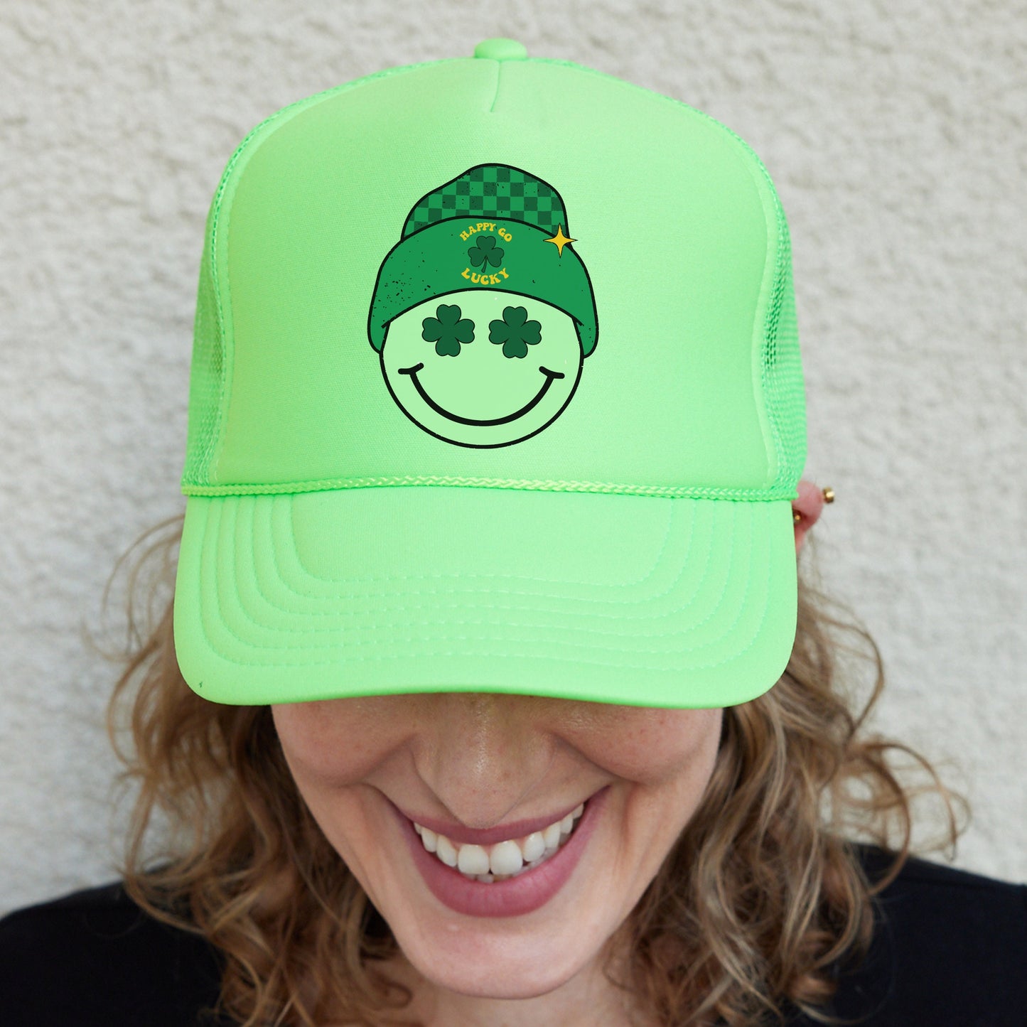 a woman wearing a green hat with a smiling face