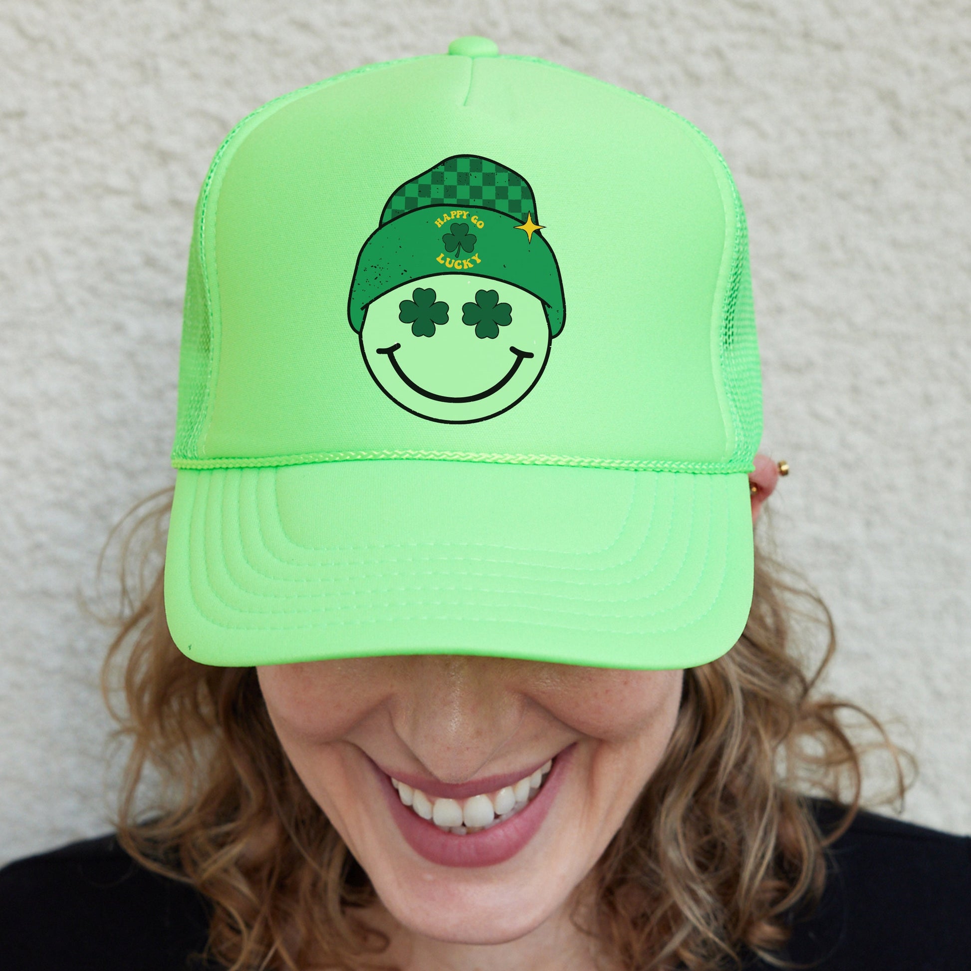a woman wearing a green hat with a smiling face