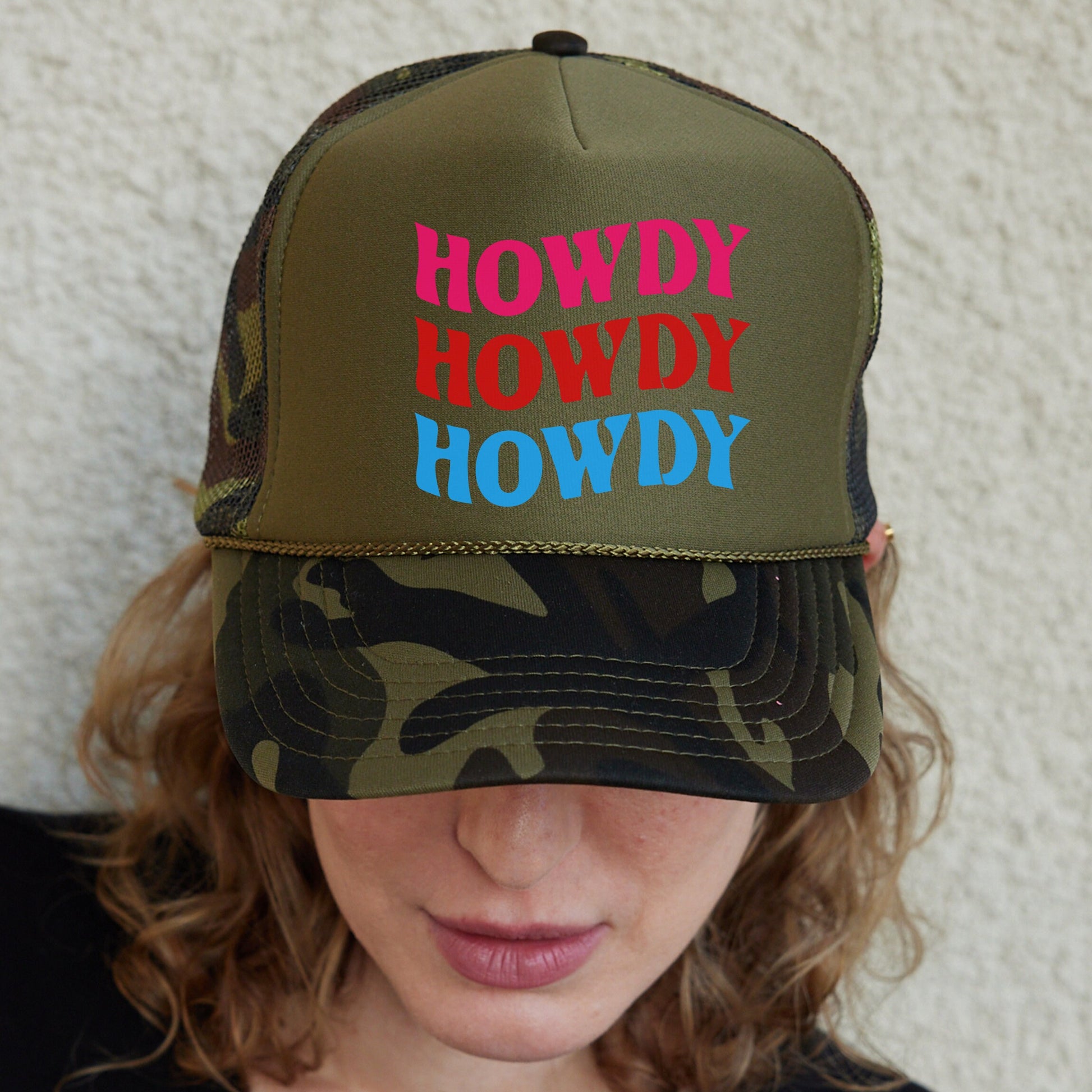 a woman wearing a hat that says howdy hoddy