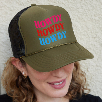 a woman wearing a trucker hat with the words hodgy howdy
